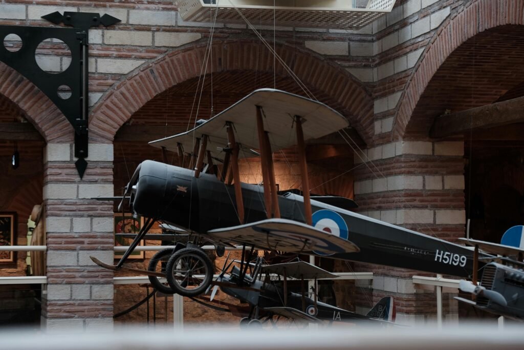 Vintage aircraft suspended in a museum, showcasing classic aviation history.