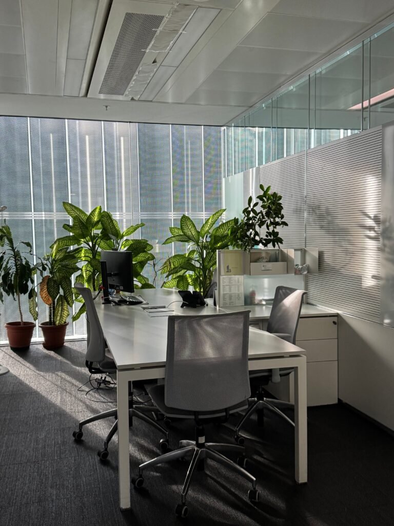 Bright, modern Milano office space with plants and natural light, perfect for productivity.